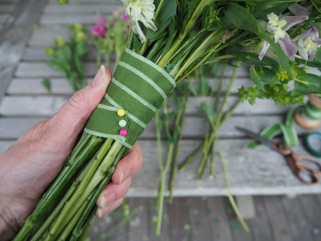 Wrapping stems with floral tape and pins