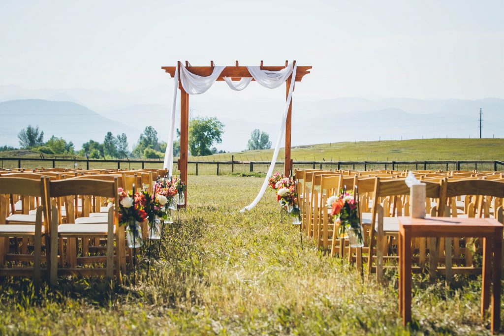 arbor in a field with flowers and greenery