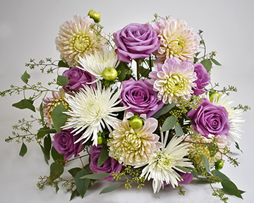 Adding dahlias to the arrangement