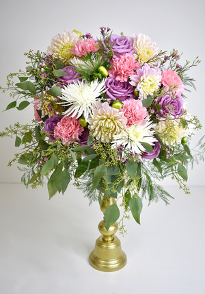 finished arrangement on candlestick pedestal