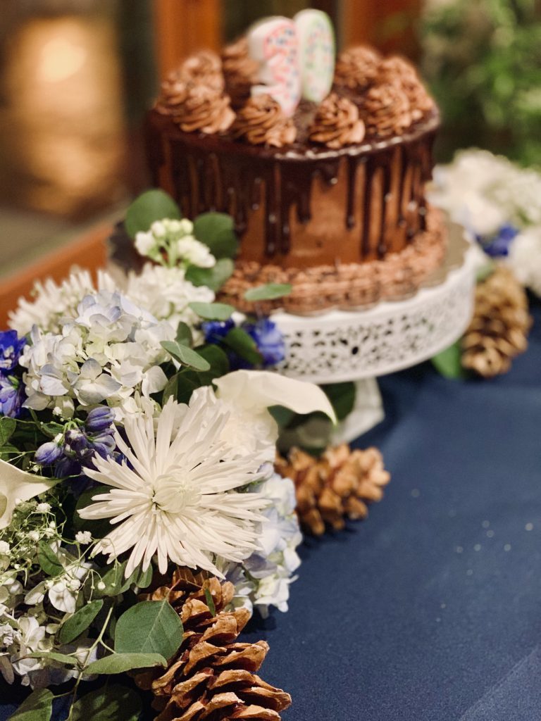 White flowers with a cake in the background