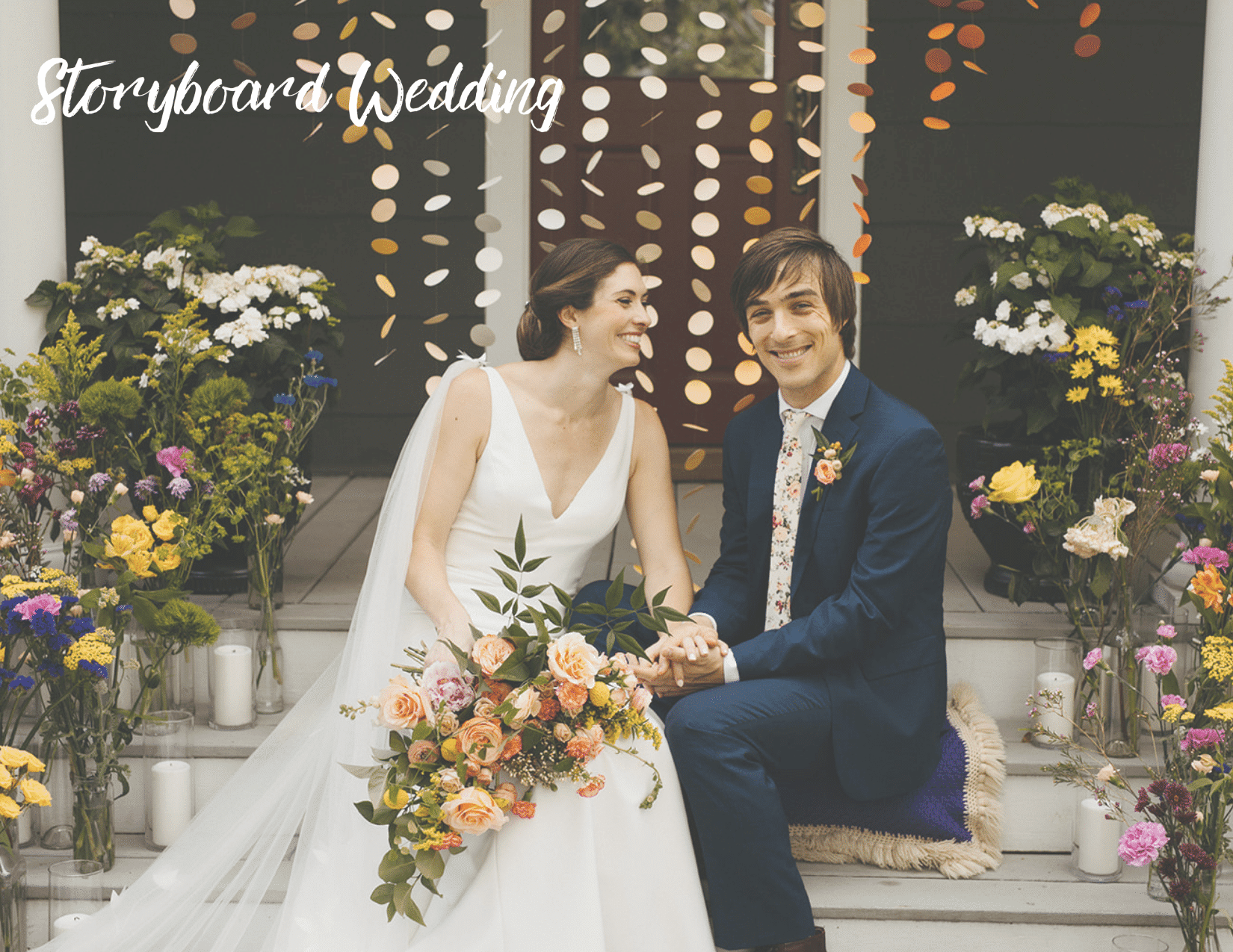 Couple sitting on stairs smiling surrounded by flowers