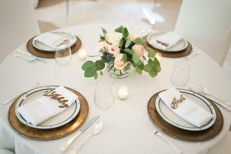 Table with place settings and floral centerpiece