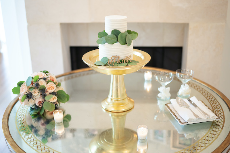 Table with small cake and flowers