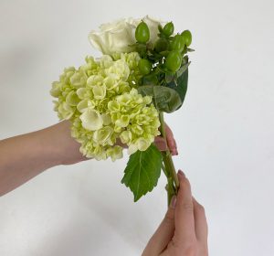 Putting flowers together to form bouquet