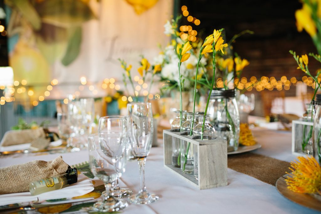 yellow flowers in mason jar table settings