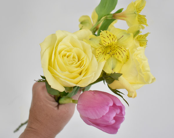 Yellow roses and purple tulips