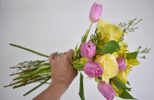 Yellow roses and purple tulips with greens