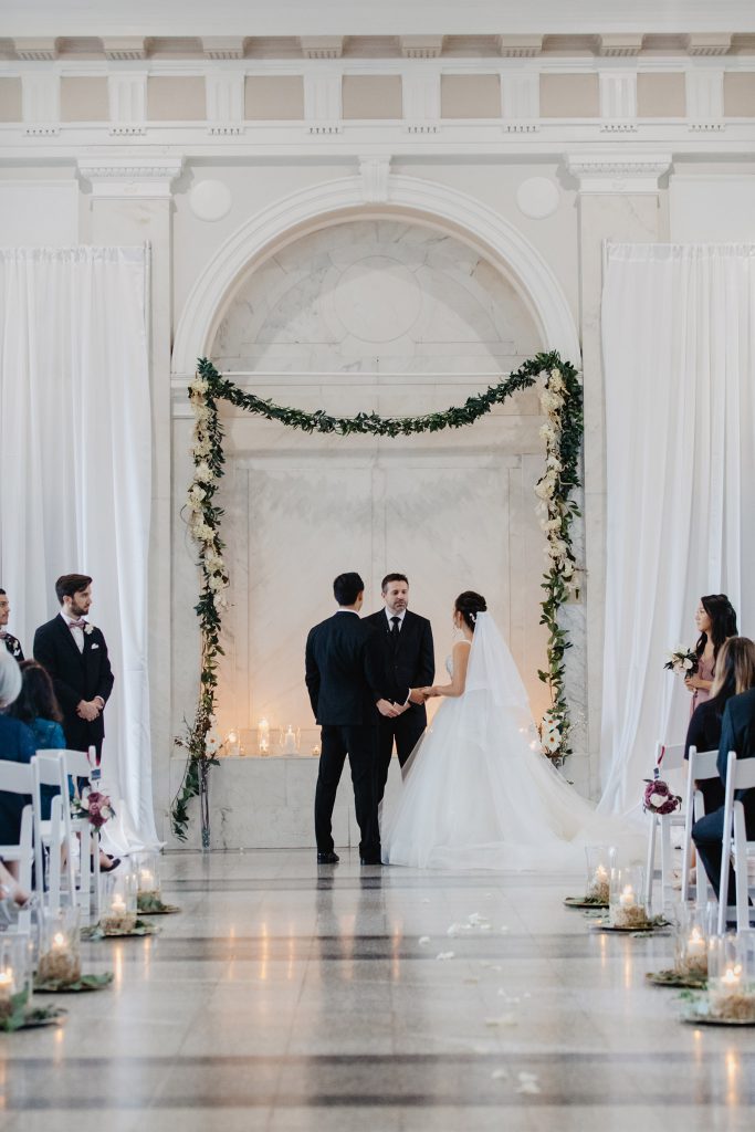 Romantic wedding ceremony with garland by Blooms by the Box