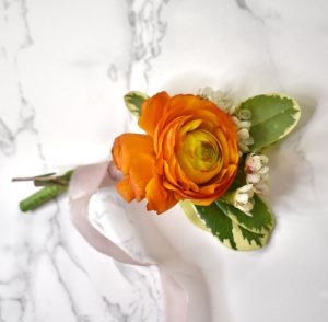 Wrapping the Ranunculus and wax flowers with ribbon