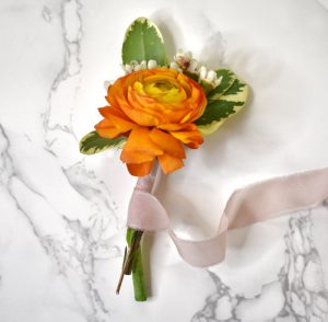 Wrapping the Ranunculus and wax flowers with ribbon