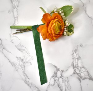 Wrapping the Ranunculus and wax flowers with floral tape