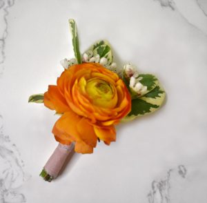 Orange ranunculus boutonniere.