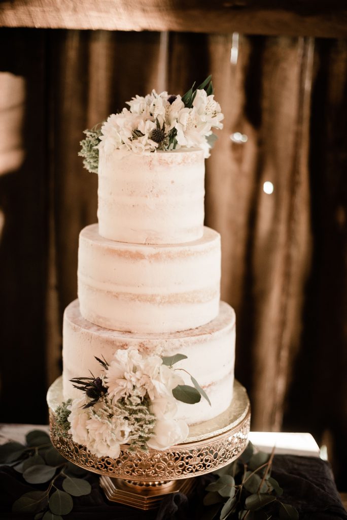 All white wedding cake with flowers