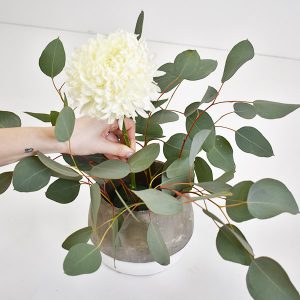 floral foam with eucalyptus branch and football mums