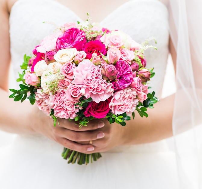 Beautiful wedding bouquet in hands of the bride.