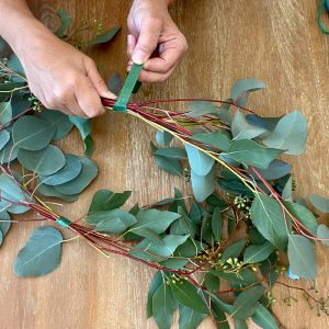 Eucalyptus Centerpiece taping stems to form a wreath