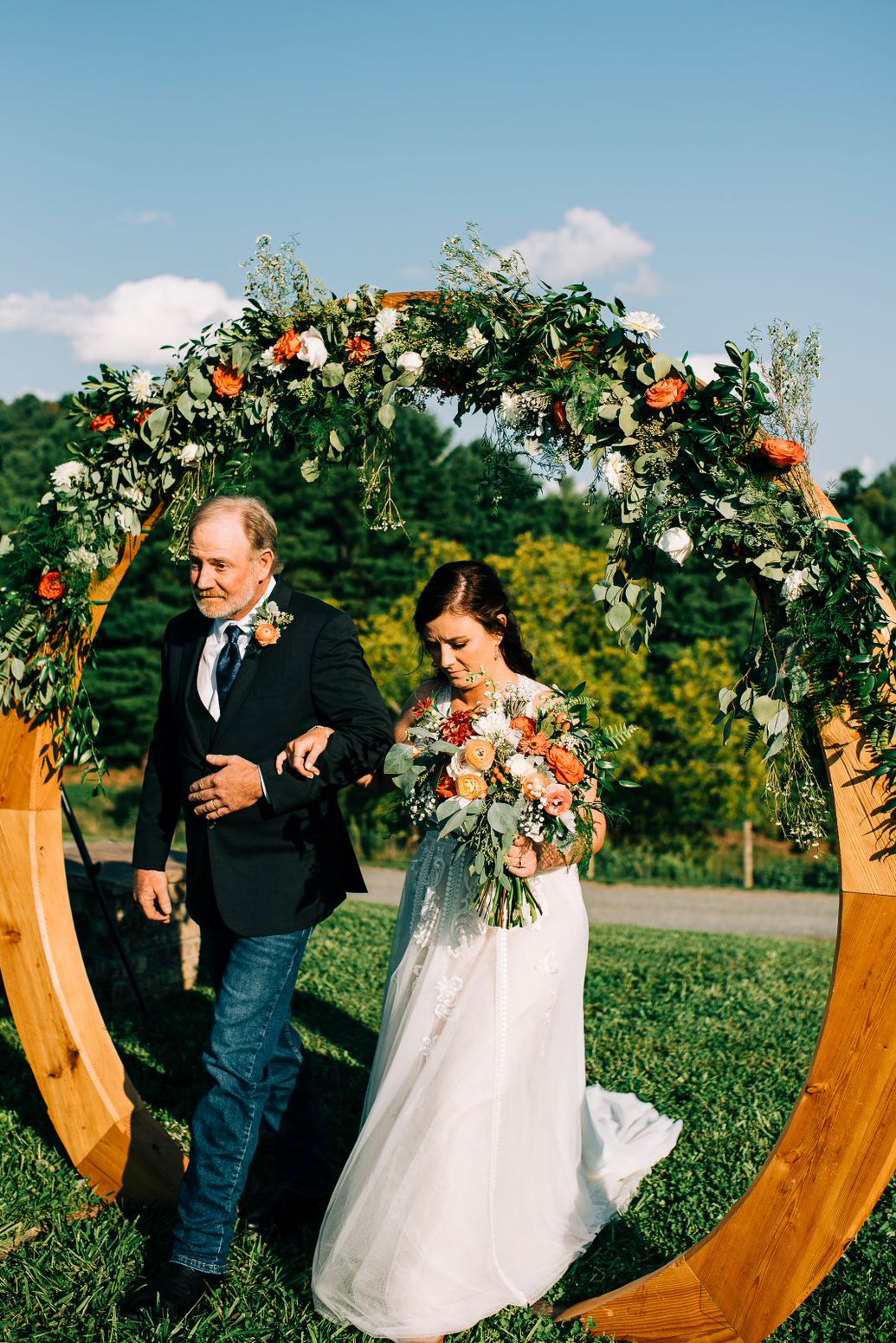 bride walking through circular wooden structure