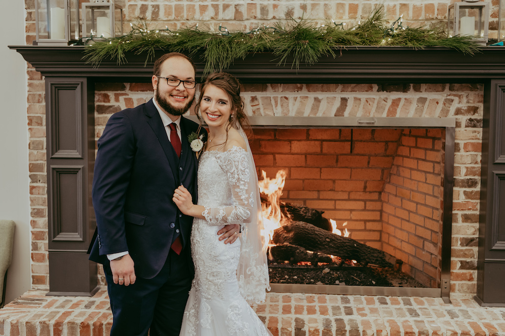 Bride and Groom in front fireplace