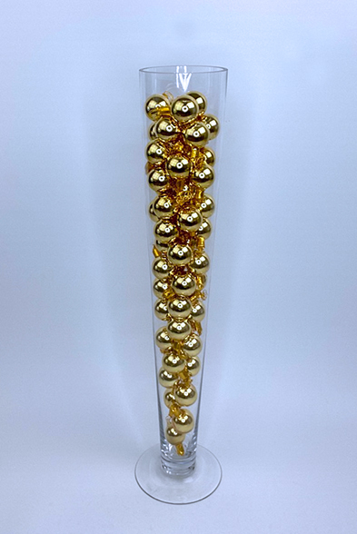 Glass filled with gold ornaments