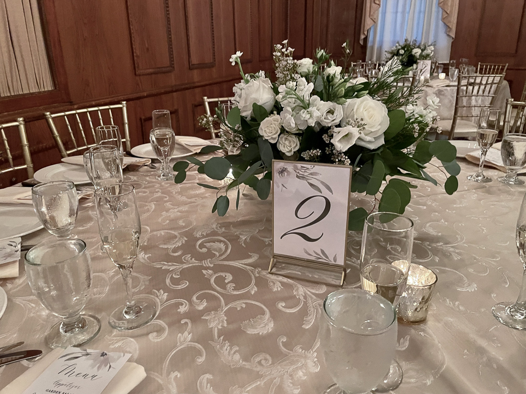 Table centerpiece with white flowers and eucalyptus