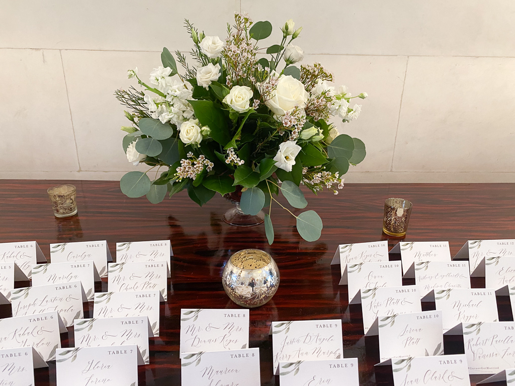 seating chart table with large floral arrangement