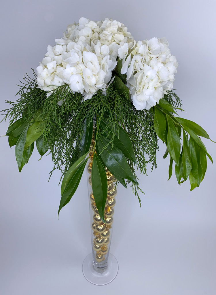 White flowers on vase with gold beads