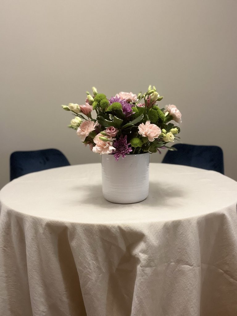 vase with greenery, carnations, lisianthus, and chyrsanthemums
