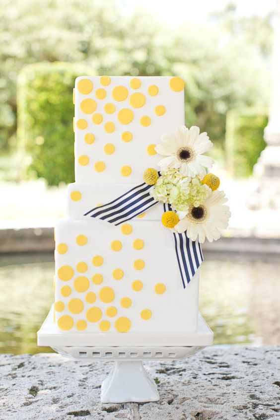 Gerbera daisies on a white & yellow cake