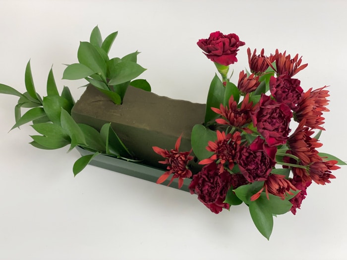  Burgundy Carnations and mums to Floral Foam