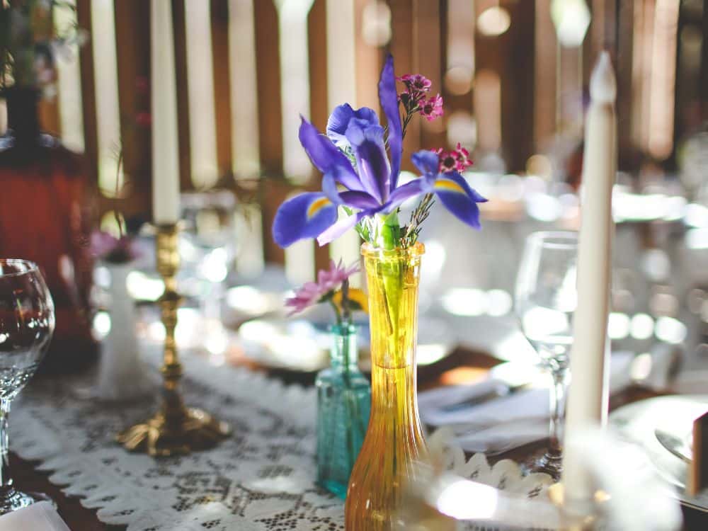 https://londonsbridgephotography.com/ February Birth Flower: Iris in a bud vase on a table.