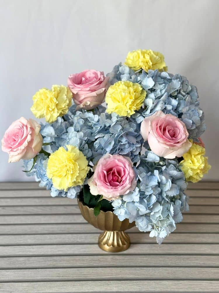 flower arrangement with hydrangeas, roses, and carnations.