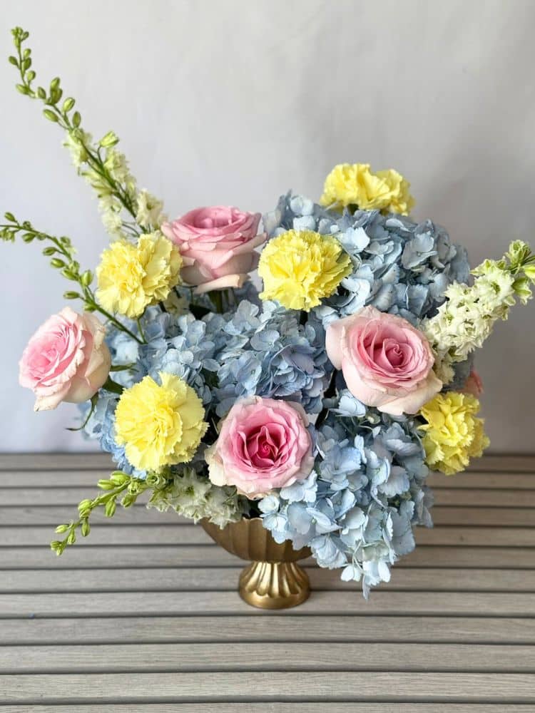 flower arrangement with hydrangeas, roses, carnations, and larkspur