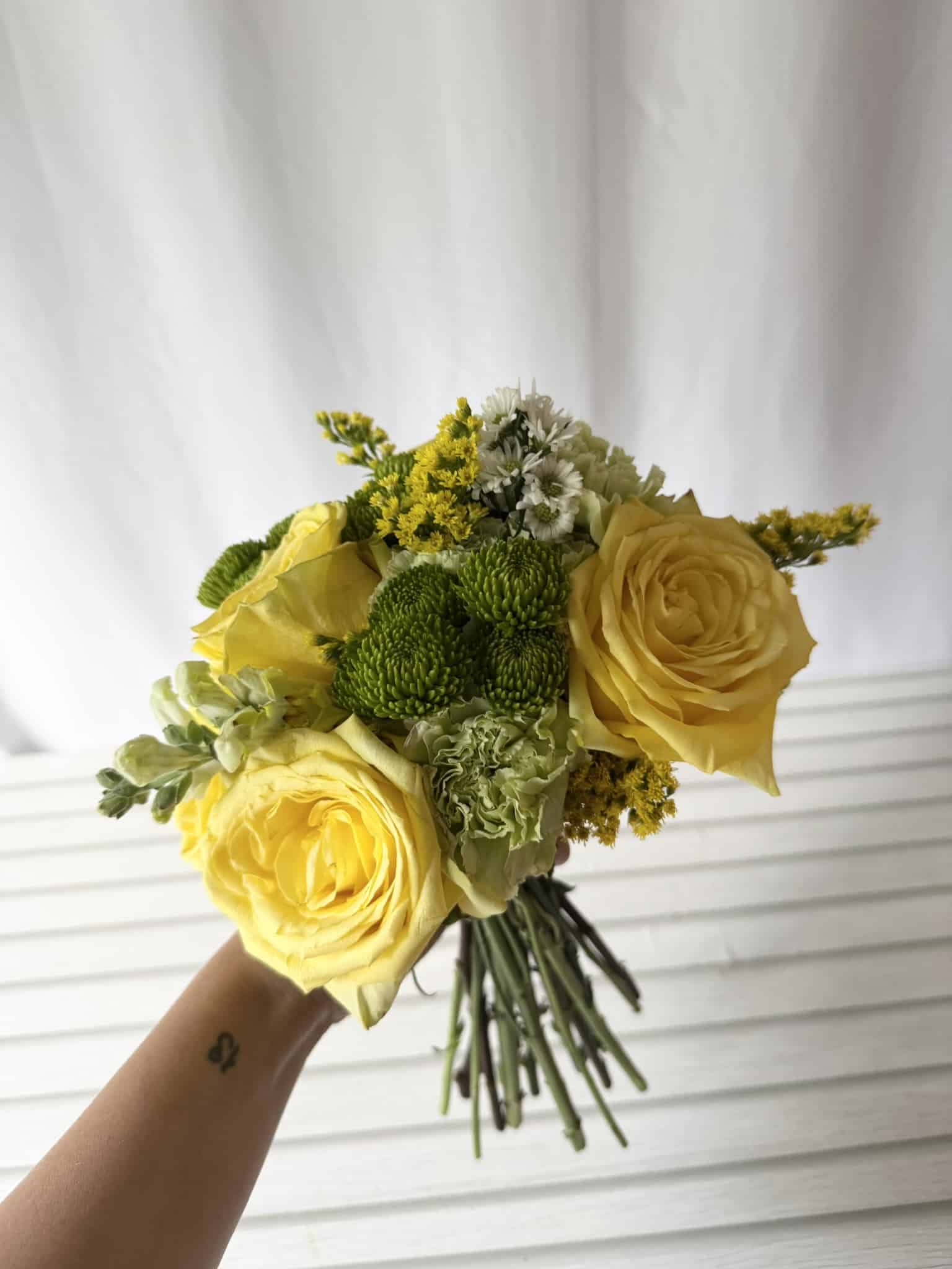 A bouquet of yellow and green flowers.