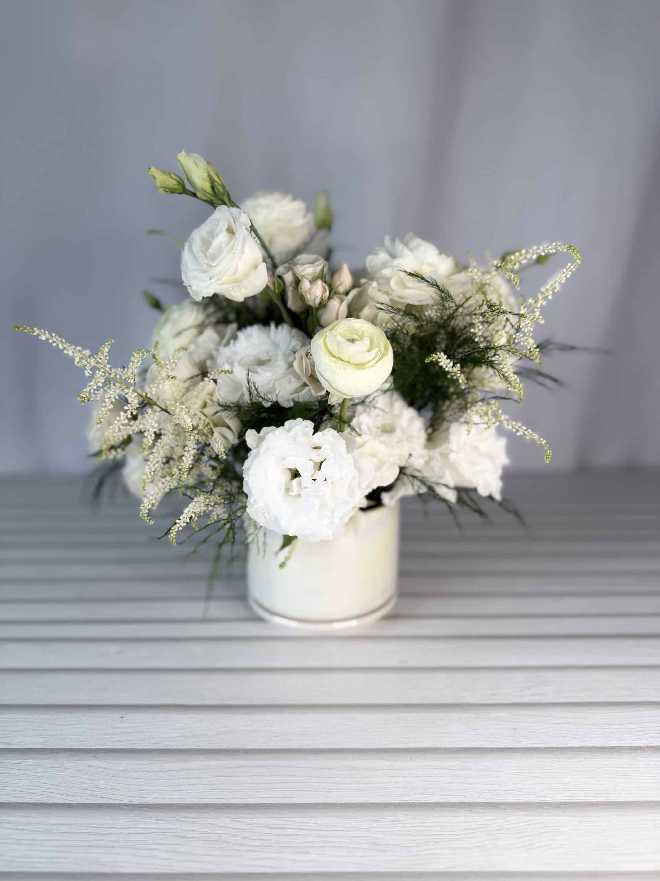 an all white flower arrangement.
