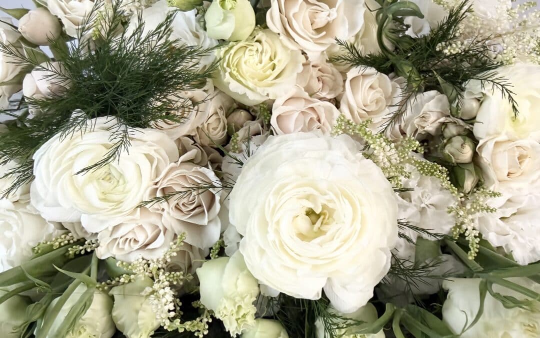 a closeup of our cloud dancer flower pack. It features lisianthus, spray roses, ranunculus, astilbe, and tree fern.